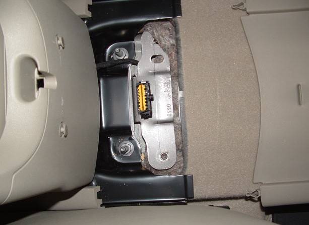On vehicles not fitted with the sliding centre console the socket is usually located under a mat/cover in the location shown.